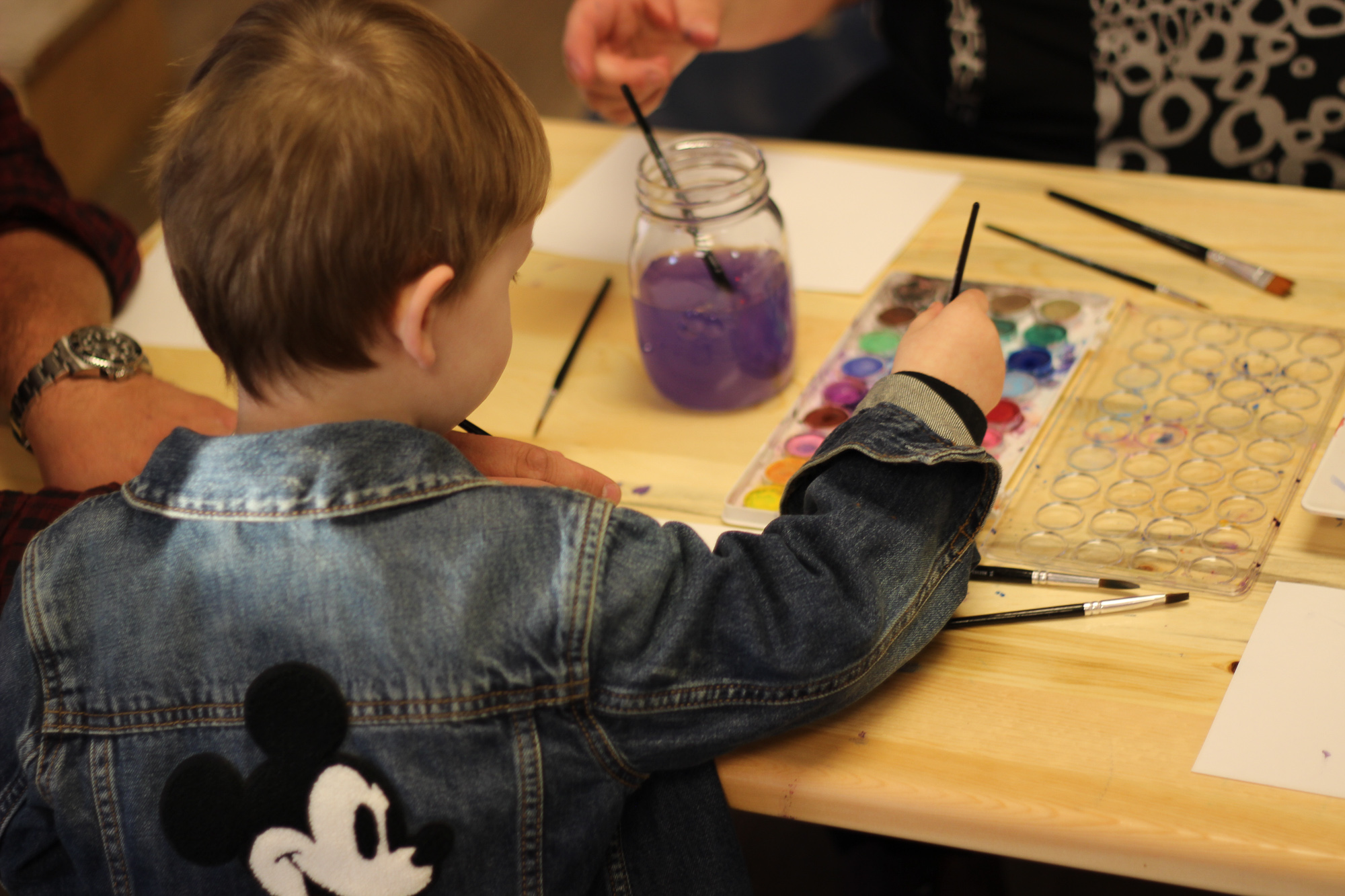 Young boy paining in an art studio at MCRC