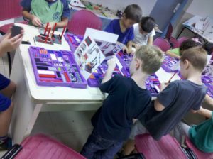 children playing with lego at a table