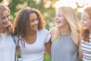 Four girls smiling together